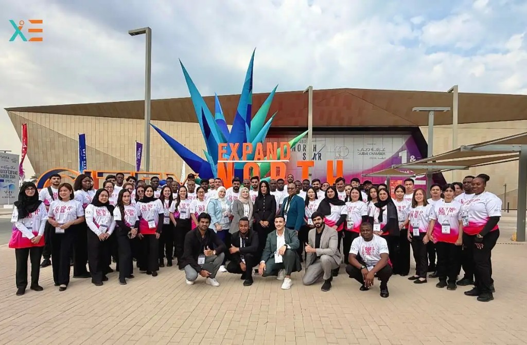 Expand North Star team in branded uniforms posing in front of the event signage at Dubai Harbour