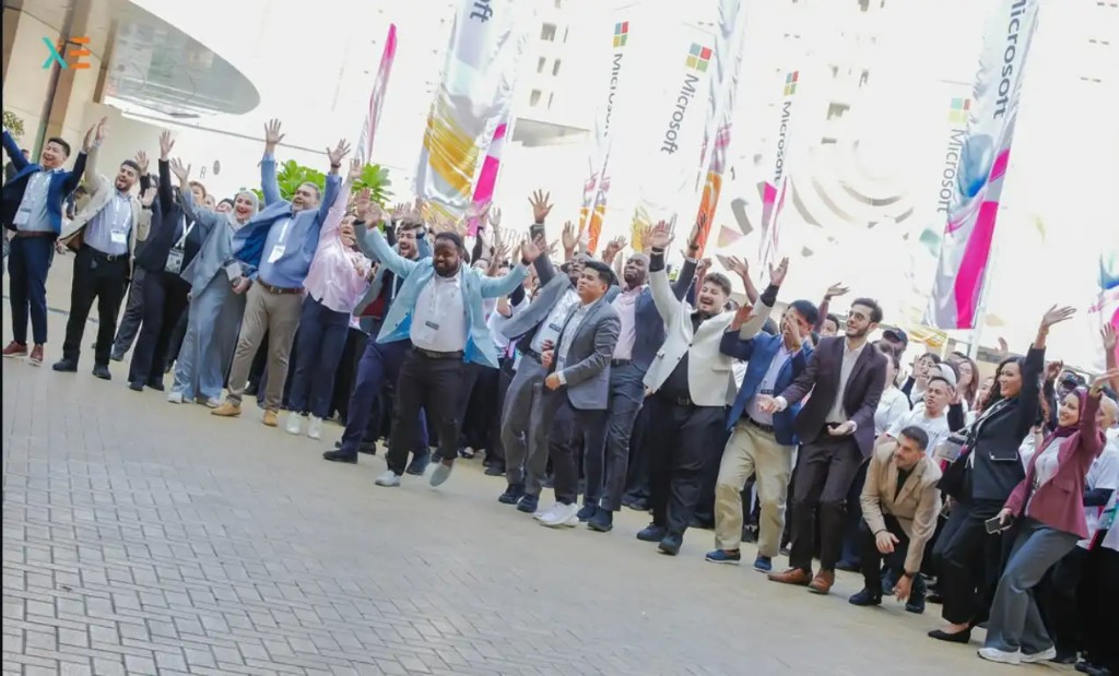 Xenial Events team celebrating at GITEX Global and Expand North Star with arms raised outside the venue