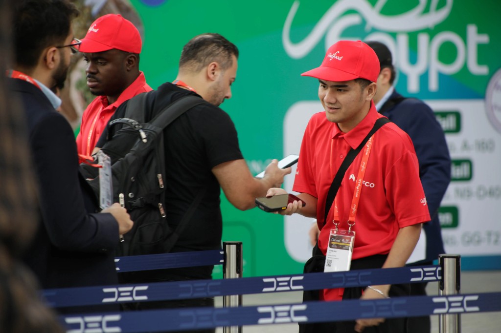 Xenial Events staff member scanning badges at a Gulfood entry point at DEC